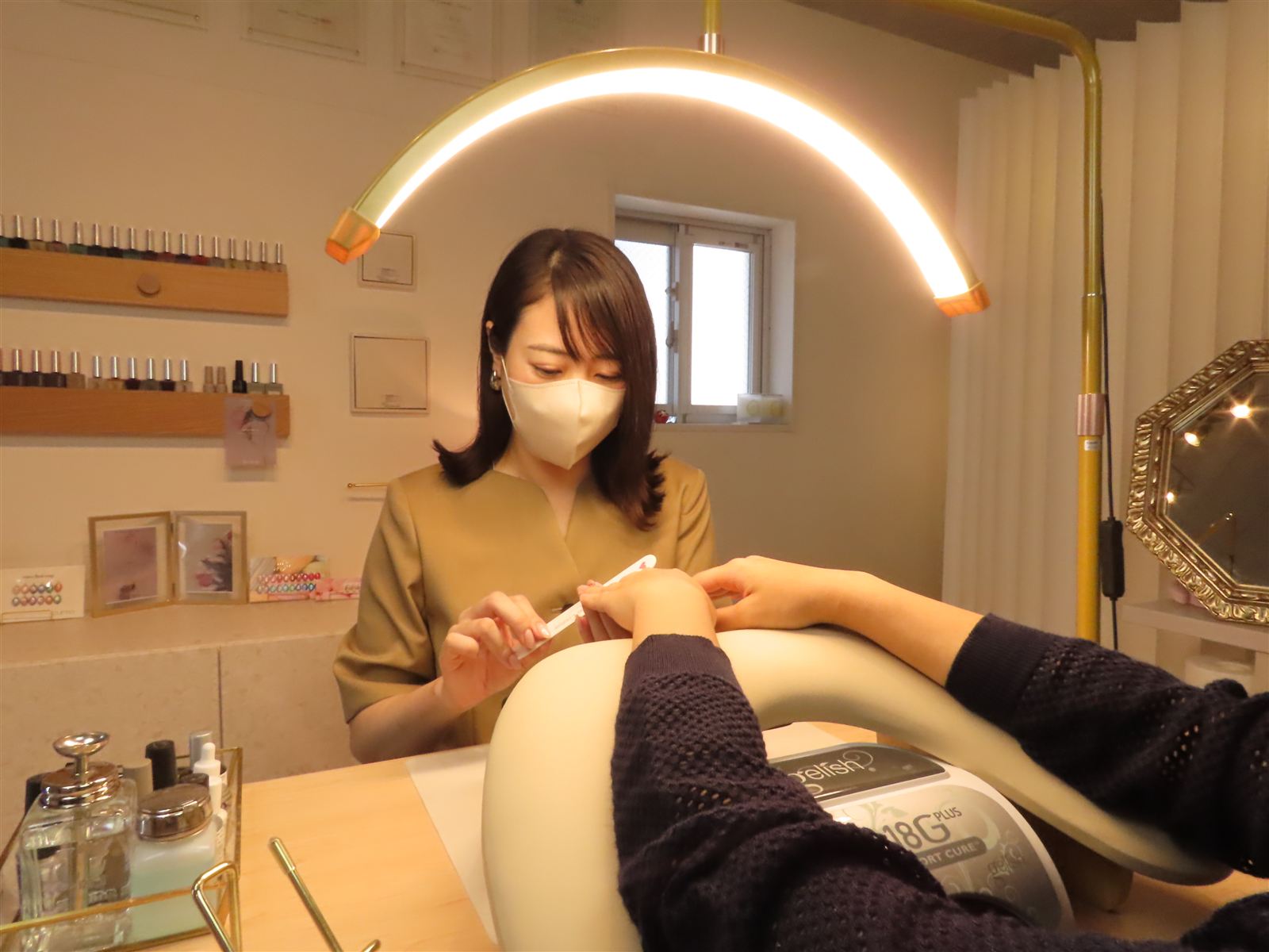 ネイリストが爪の形を整えているところ